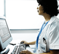 QA Portal - Image of a physician working on a computer